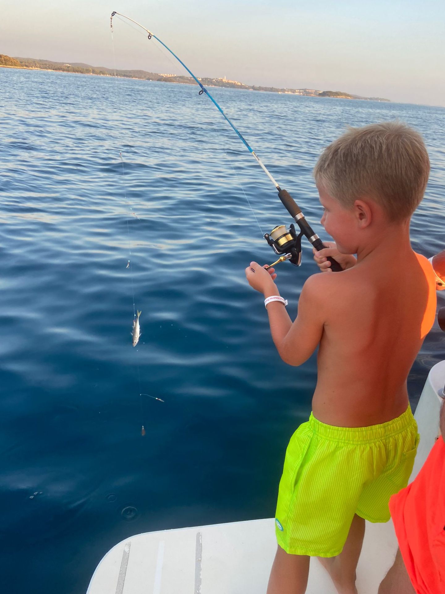 Young guest reeling in a catch
