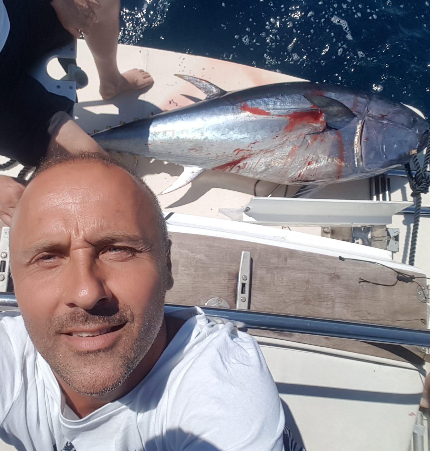 Captain with a large Bluefin tuna aboard Tunatail