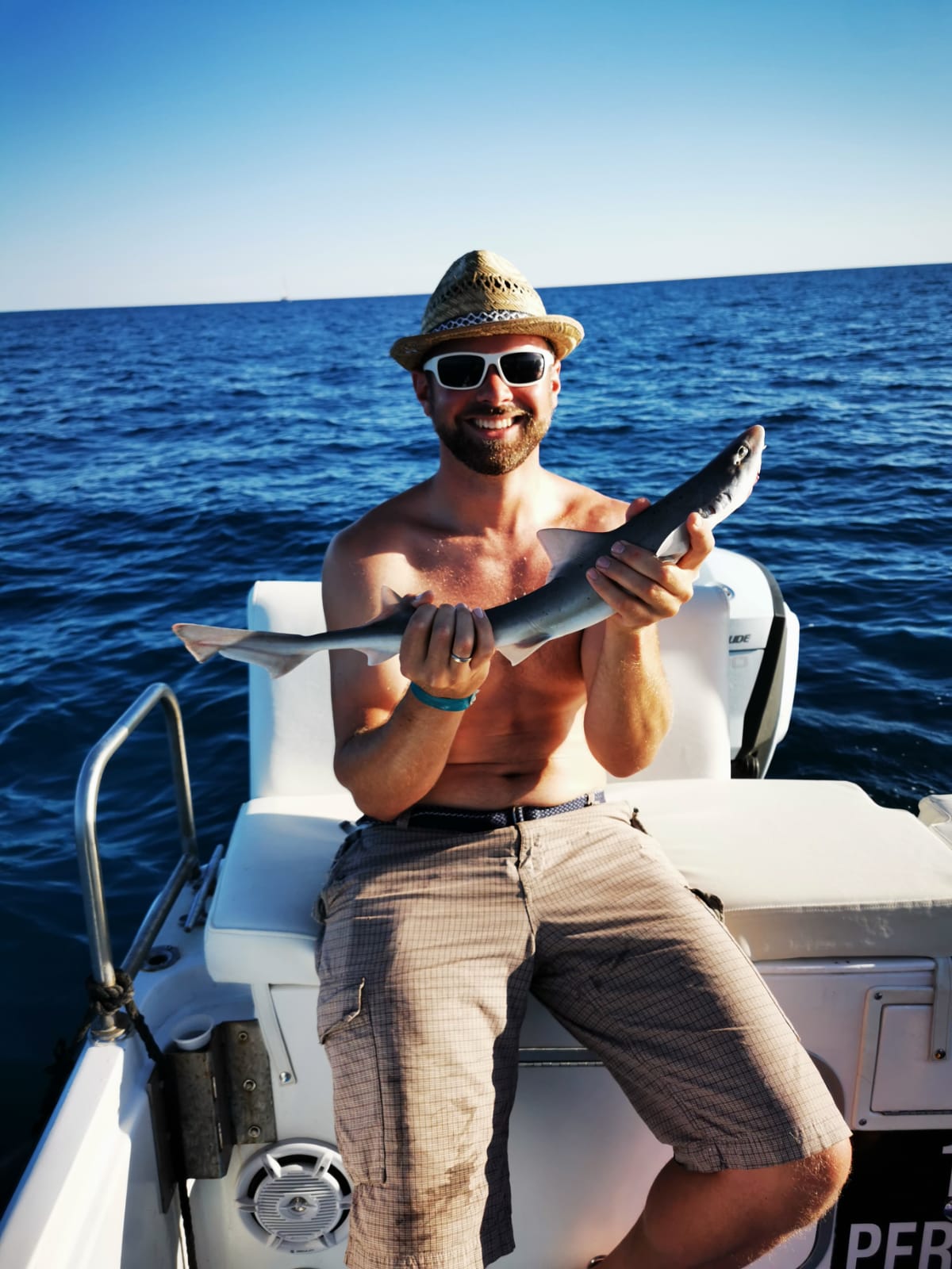Guest holding a small shark before release