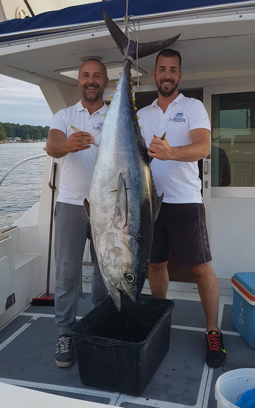 Crew with a giant Bluefin tuna on deck