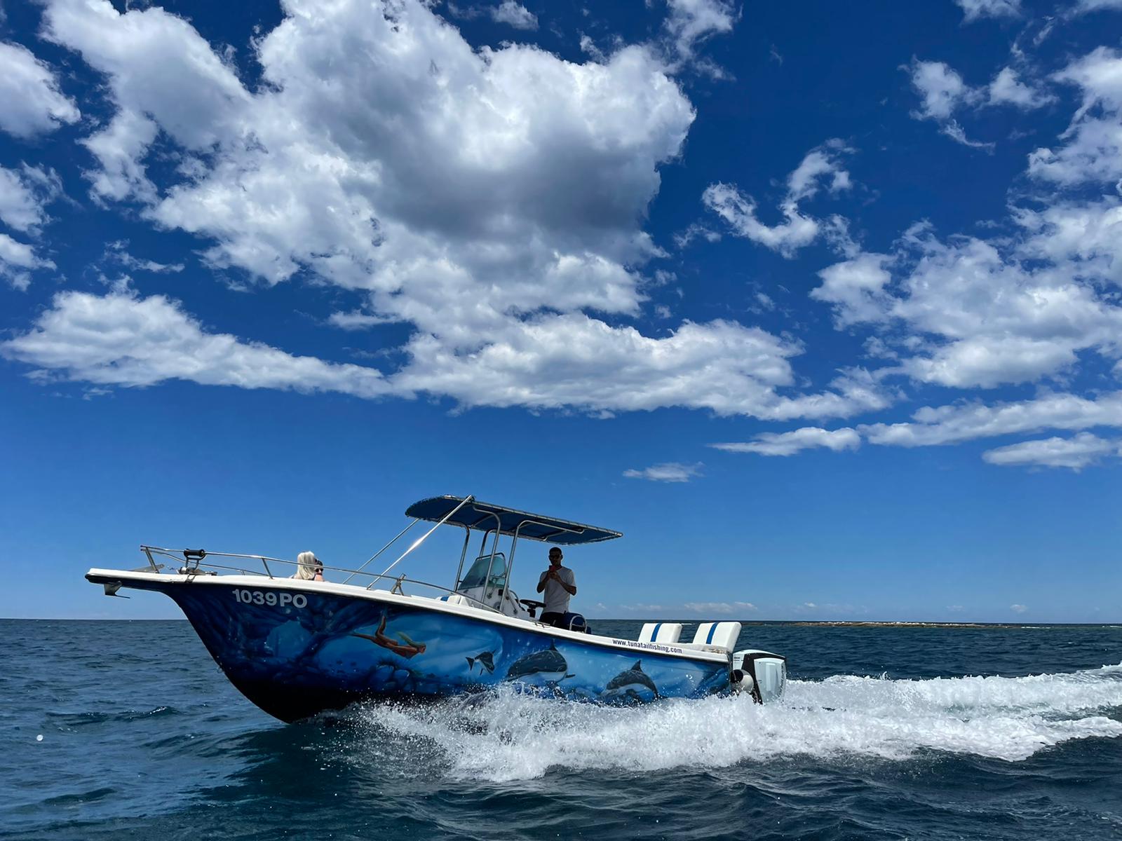 Tunatail boat cruising under bright sky