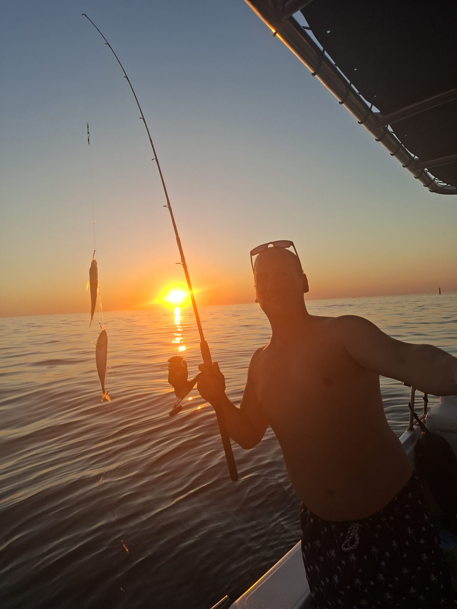 Sunset fishing with fish on the line